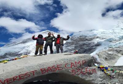 Tourists enjoying as the Everest base camp 5364m with the beer in hand.